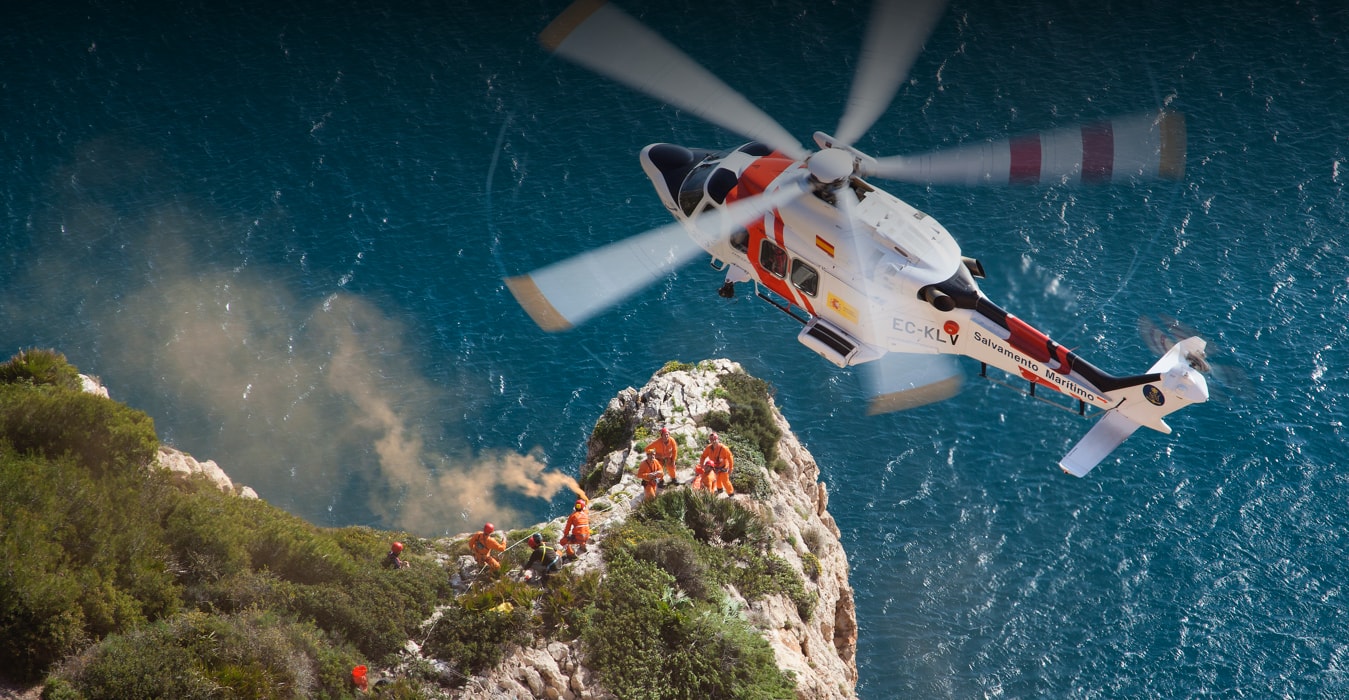 Babcock search and rescue helicopter flying above the Mediterranean coast